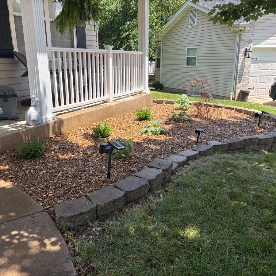 The same front bed replanted with fresh mulch and a reset border, St. Charles