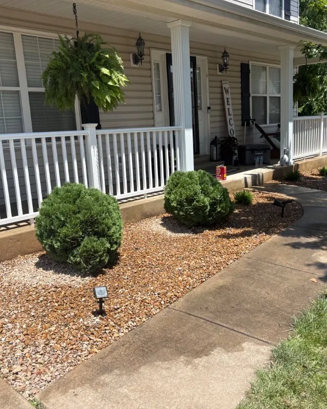 Fresh rock bed with new plantings and a block border, O'Fallon