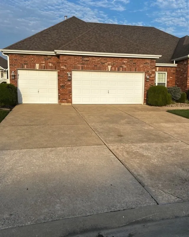 Soft-washed concrete driveway at a brick home, O'Fallon
