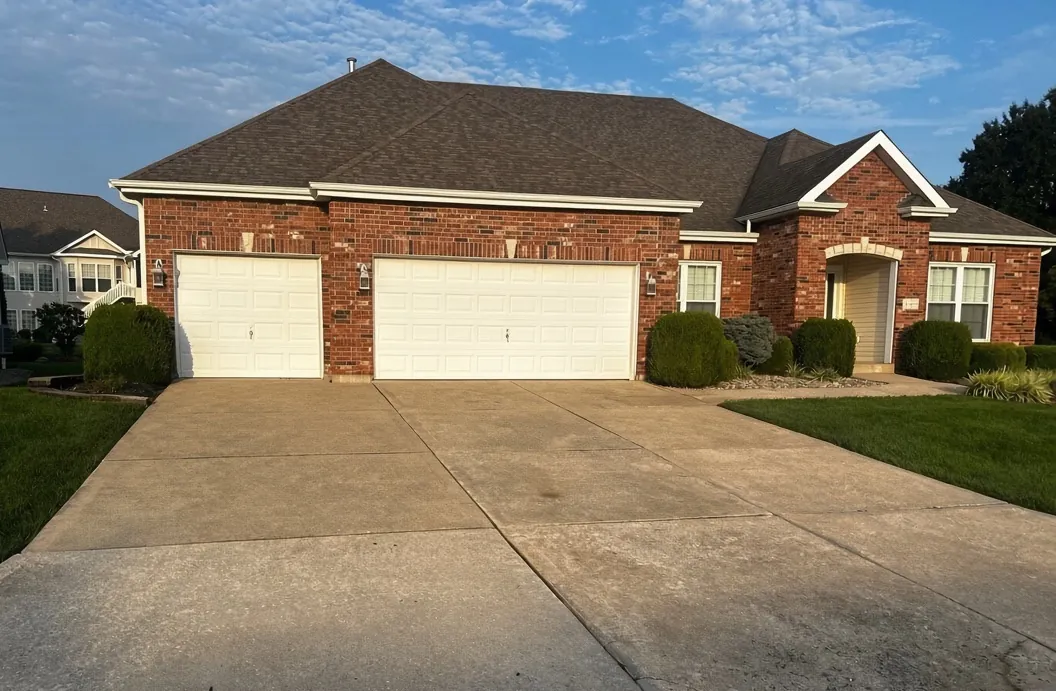 Finished driveway soft wash on a brick home in O'Fallon