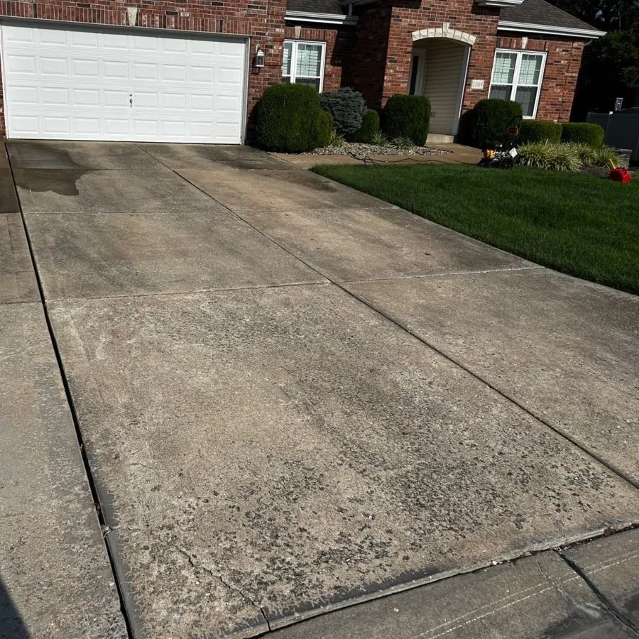 Stained concrete driveway part way through washing, O'Fallon